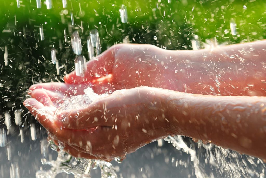 Switch business water supplier - Hands catching clean falling water